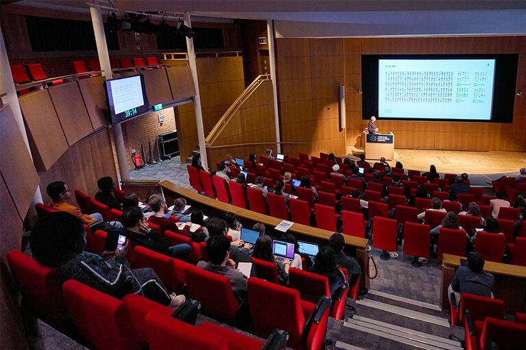 The Francis Crick Auditorium, shot of the stage down tiered seating.